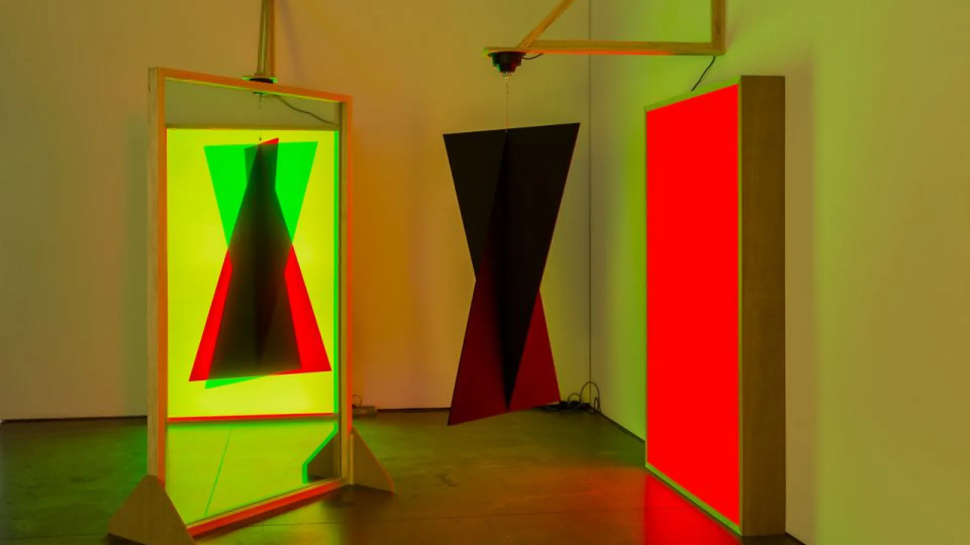 Taree Mackenzie, Pepper’s ghost effect, double triangles, red and yellow, 2018. Acrylic, composition board, reflective tint, LED, mirror ball motor, paint, wood, vinyl. Dimensions variable. Photo by Christo Crocker